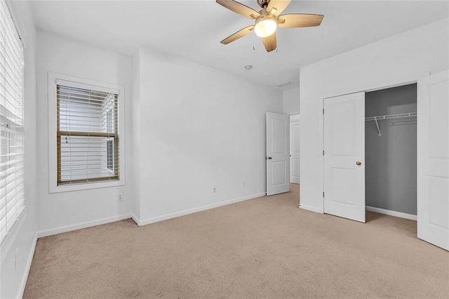 unfurnished bedroom featuring light carpet, ceiling fan, and a closet