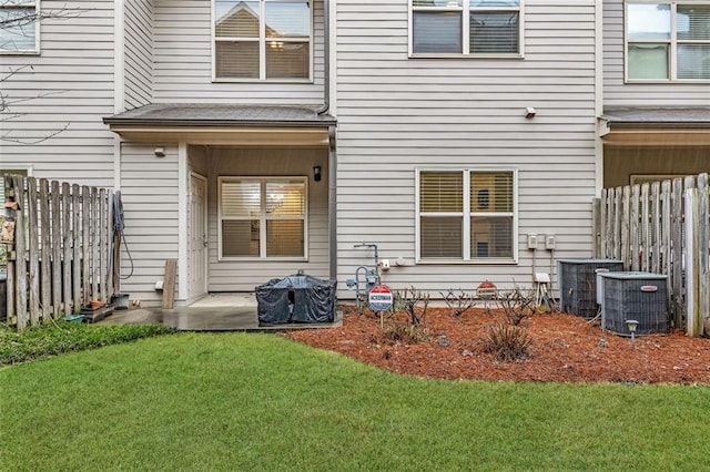 rear view of property featuring a yard and a patio