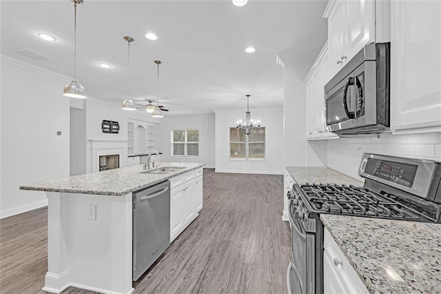 kitchen featuring a kitchen island with sink, white cabinets, and appliances with stainless steel finishes