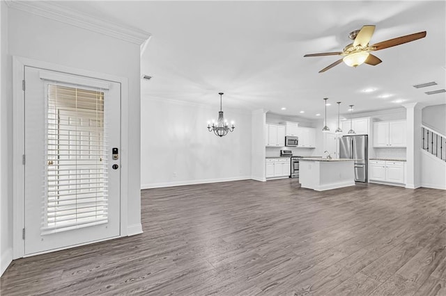 unfurnished living room featuring sink, ceiling fan with notable chandelier, ornamental molding, and dark hardwood / wood-style floors