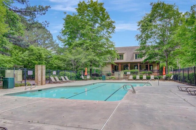 view of pool featuring fence and a patio area