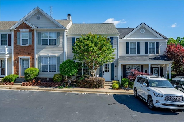multi unit property featuring uncovered parking and a chimney