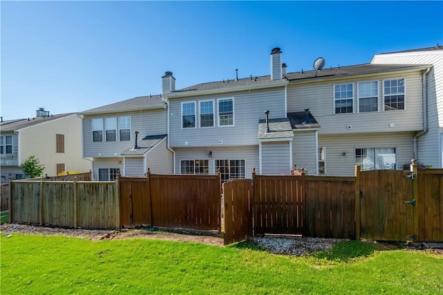 back of property with a gate and a chimney