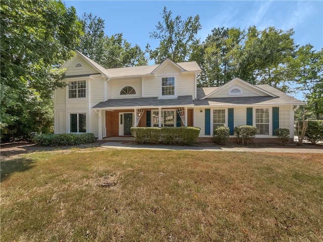 traditional home with brick siding and a front yard