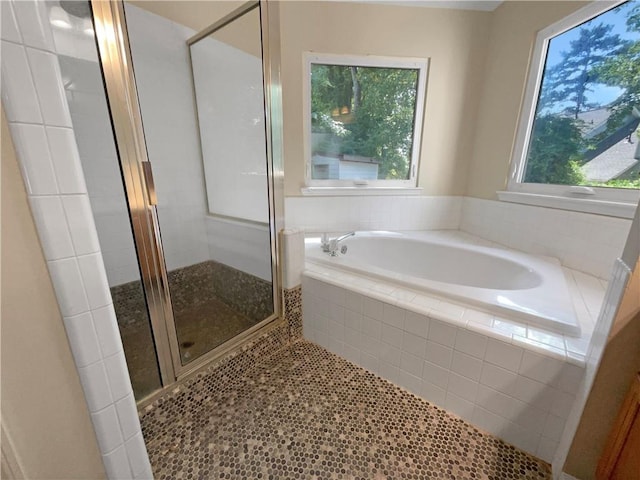 bathroom with tile patterned flooring and shower with separate bathtub