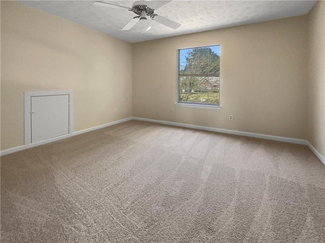 spare room with a textured ceiling, ceiling fan, and carpet flooring