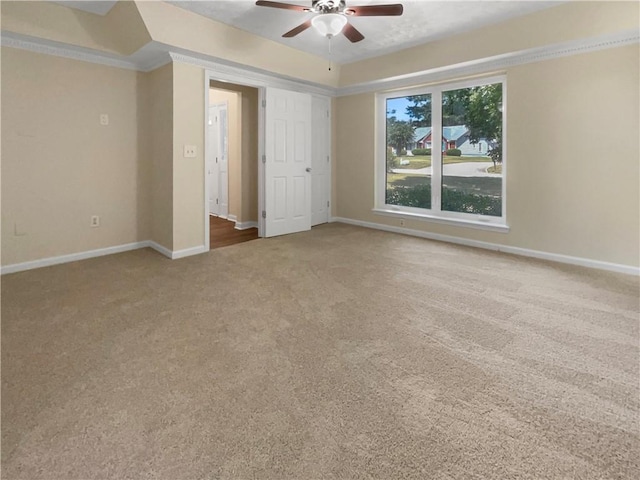 unfurnished bedroom with ornamental molding, light colored carpet, and ceiling fan