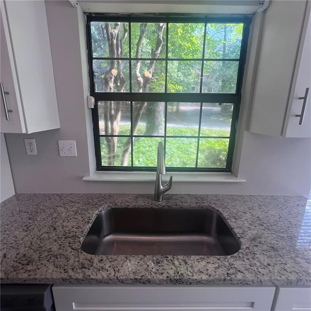 3045 Steeplechase, Alpharetta, GA 30004 - kitchen view of a sink, white cabinetry, and light stone counters