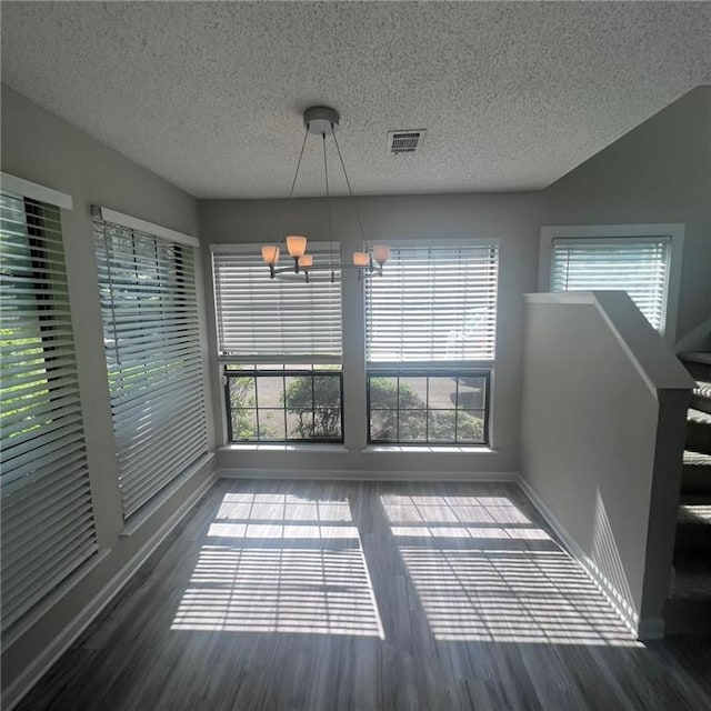 3045 Steeplechase, Alpharetta, GA 30004 - unfurnished dining area featuring baseboards, a chandelier, wood finished floors, and a textured ceiling