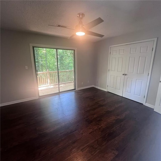 3045 Steeplechase, Alpharetta, GA 30004 - unfurnished bedroom with access to outside, dark wood finished floors, baseboards, ceiling fan, and a textured ceiling