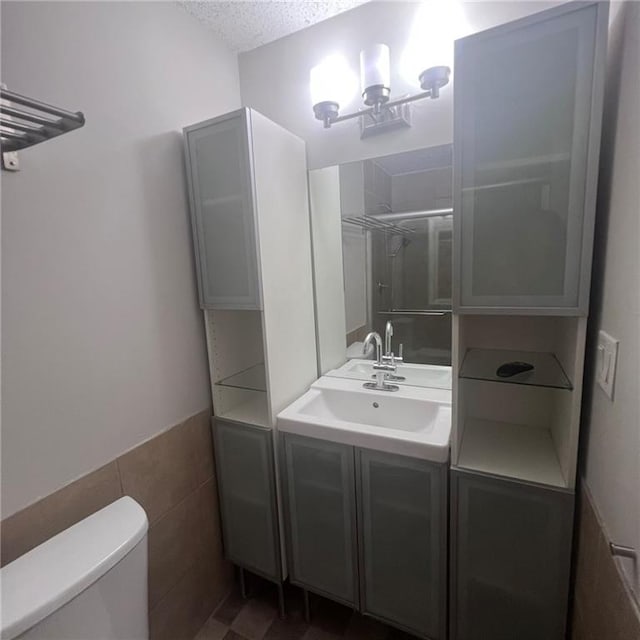 3045 Steeplechase, Alpharetta, GA 30004 - full bath with vanity, toilet, a textured ceiling, a shower, and tile walls