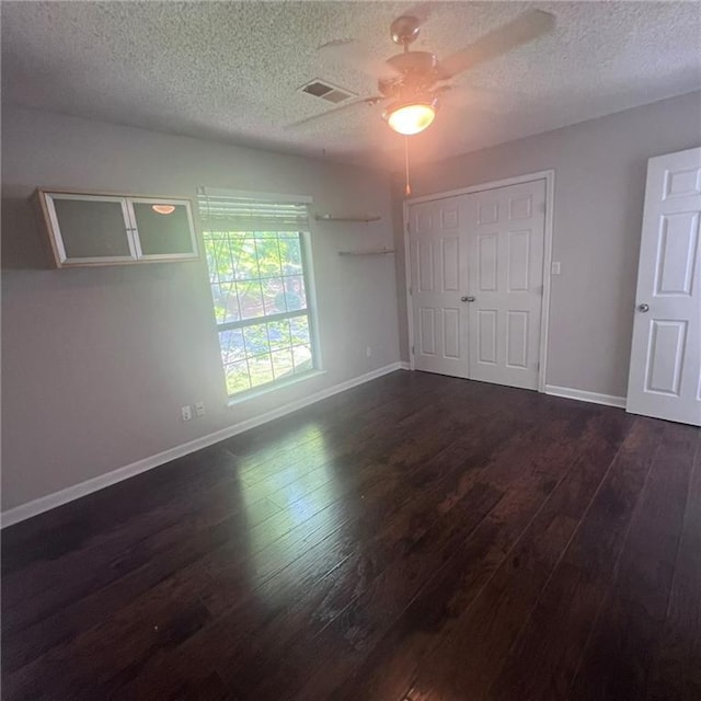 3045 Steeplechase, Alpharetta, GA 30004 - unfurnished bedroom with dark wood-style flooring, a textured ceiling, baseboards, and ceiling fan
