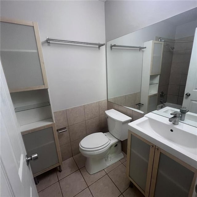 3045 Steeplechase, Alpharetta, GA 30004 - bathroom with tile patterned floors, toilet, vanity, a shower, and tile walls