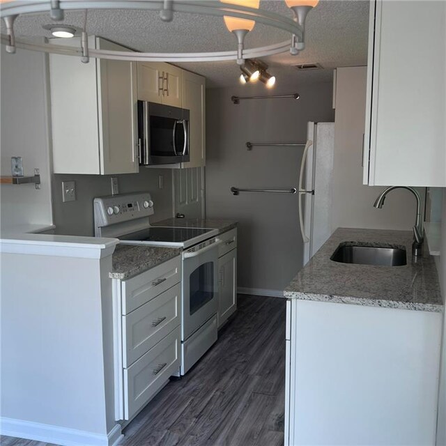 3045 Steeplechase, Alpharetta, GA 30004 - kitchen featuring white appliances, a sink, dark wood finished floors, baseboards, and light stone countertops