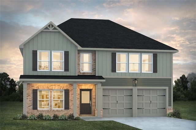 view of front of home with a garage and a yard