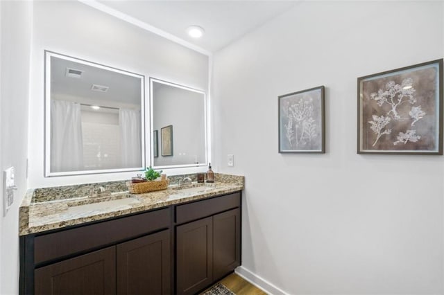 bathroom with hardwood / wood-style floors and vanity