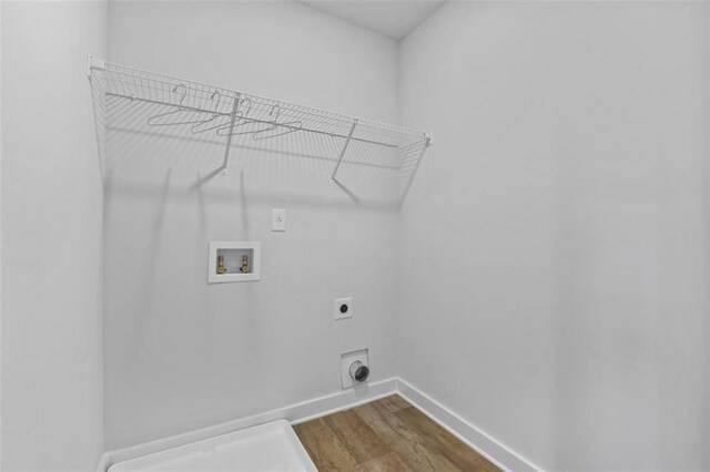 laundry room with hardwood / wood-style floors, electric dryer hookup, and hookup for a washing machine