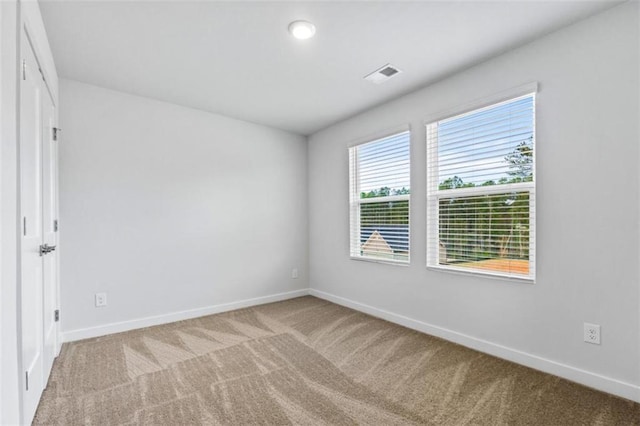 empty room featuring light colored carpet