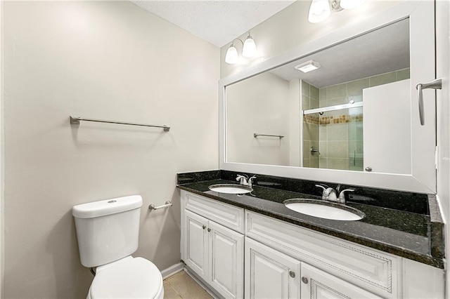 1386 Heritage Glen Dr, Marietta, GA 30068 - bathroom featuring double vanity, tiled shower, tile patterned flooring, and a textured ceiling