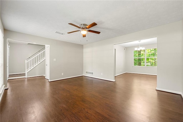 1386 Heritage Glen Dr, Marietta, GA 30068 - unfurnished room with wood finished floors, a ceiling fan, stairs, a chandelier, and a textured ceiling