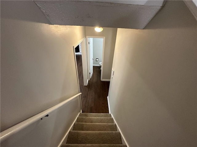 stairs featuring baseboards and wood finished floors