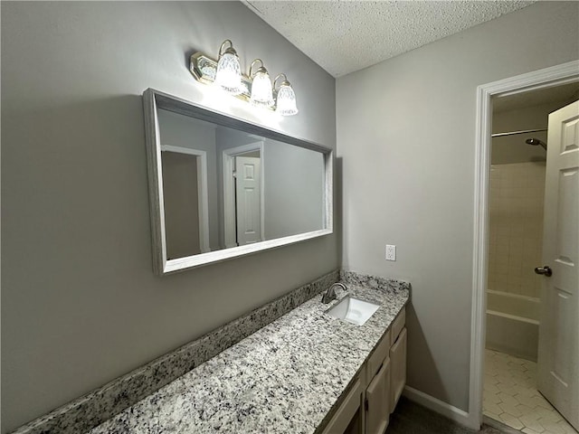 bathroom with shower / bathtub combination, a textured ceiling, and vanity