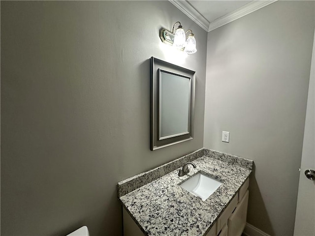 half bathroom featuring vanity and crown molding