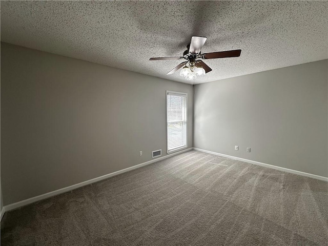 carpeted spare room featuring visible vents, a textured ceiling, baseboards, and a ceiling fan