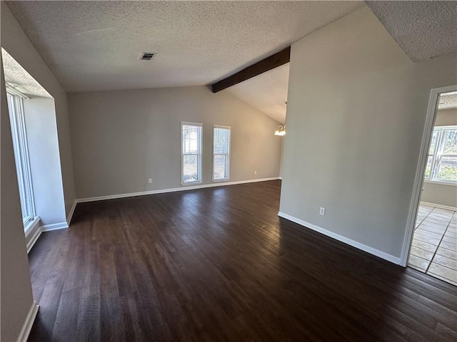 spare room with baseboards, visible vents, dark wood finished floors, an inviting chandelier, and a textured ceiling