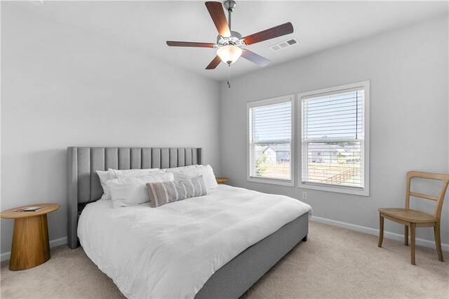 bedroom featuring light carpet and ceiling fan