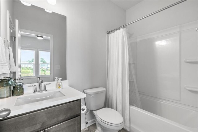 full bathroom with shower / bath combination with curtain, toilet, and vanity