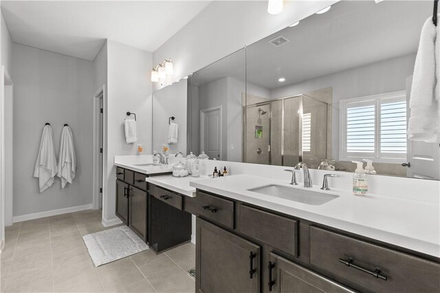 bathroom featuring vanity, tile patterned flooring, and a shower with door