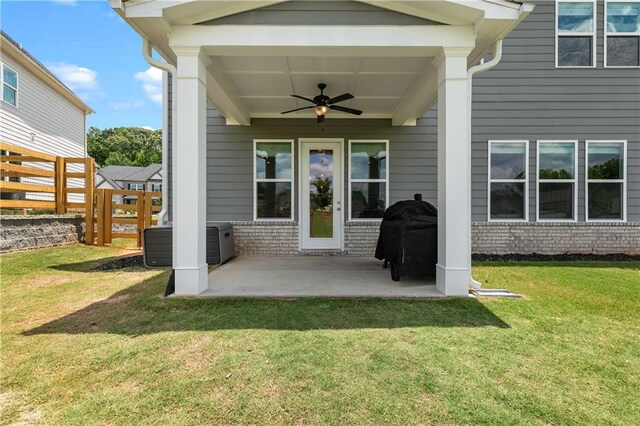 exterior space with a yard, cooling unit, a patio, and ceiling fan