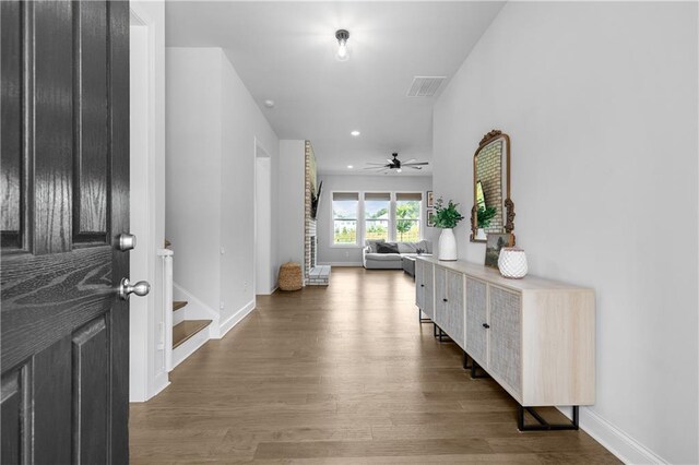 foyer entrance with dark hardwood / wood-style floors and ceiling fan