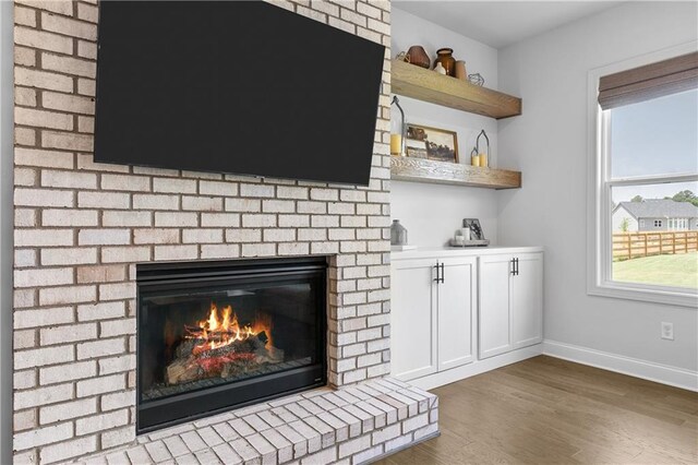 interior details with hardwood / wood-style floors and a fireplace