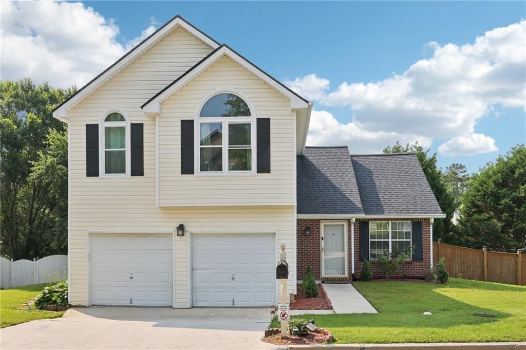 7033 Brecken Trce, Lithonia, GA 30058 - view of front of house featuring concrete driveway, an attached garage, and brick siding
