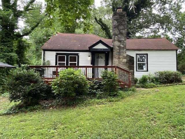 2463 Stone Rd, East Point, GA 30344 - view of front facade featuring a front yard, a shingled roof, a wooden deck, and a chimney
