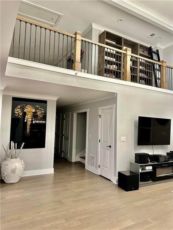 living room featuring crown molding and hardwood / wood-style floors