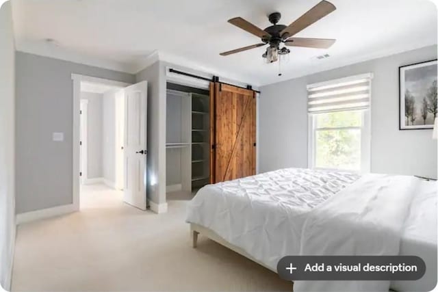 bedroom featuring a barn door, carpet, and ceiling fan