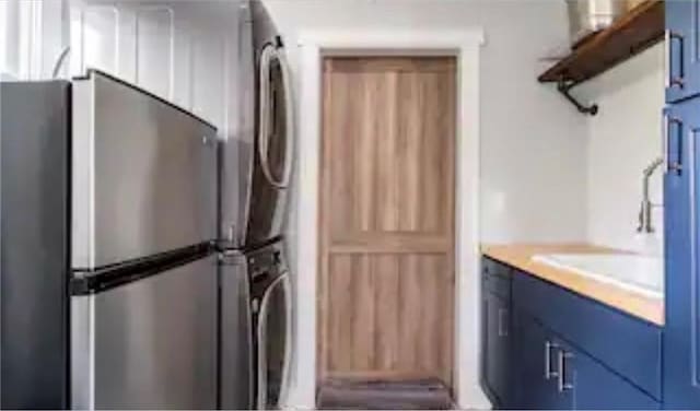 interior space featuring blue cabinetry and stainless steel fridge