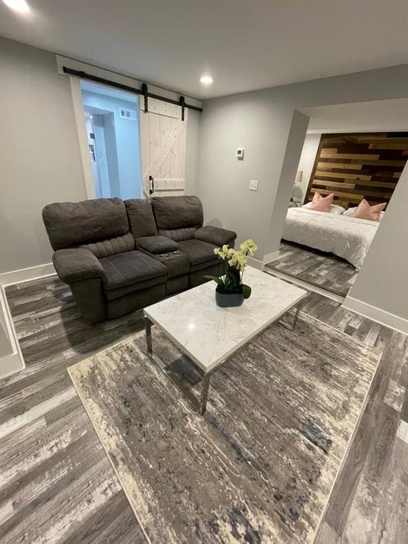 living room featuring hardwood / wood-style floors and a barn door