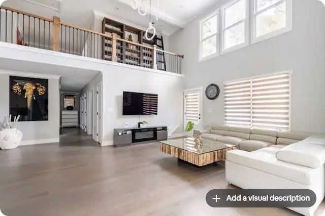 living room featuring a high ceiling and wood-type flooring