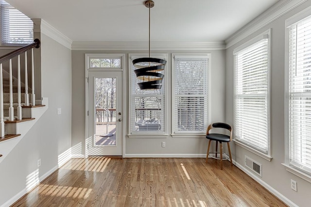 interior space featuring light wood-type flooring and ornamental molding