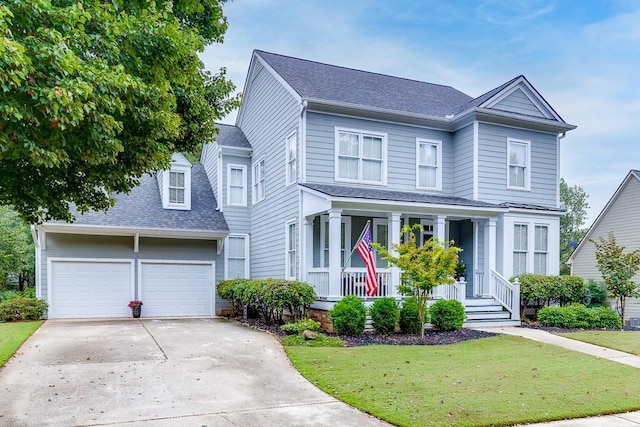 view of front of property with a porch, a garage, and a front lawn