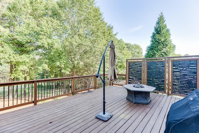 wooden deck with an outdoor fire pit