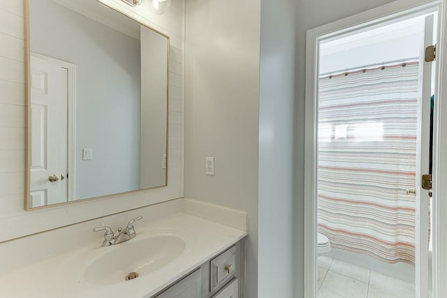 bathroom featuring tile patterned floors, vanity, a shower with shower curtain, and toilet