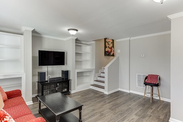 living room featuring built in shelves, dark hardwood / wood-style floors, and ornamental molding