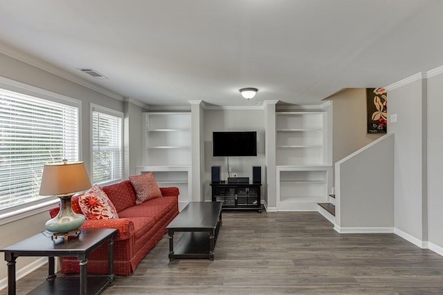 living room with crown molding, plenty of natural light, and dark hardwood / wood-style floors