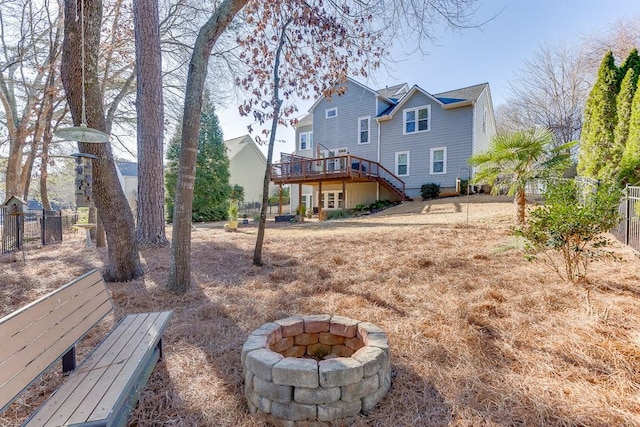 view of yard with an outdoor fire pit and a wooden deck