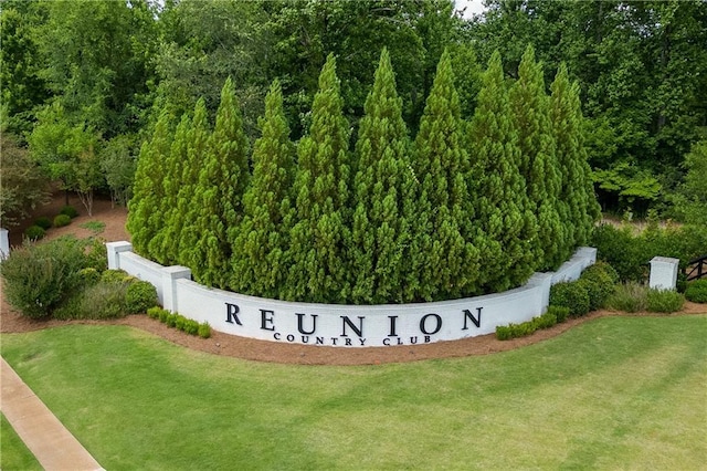 community sign featuring a lawn